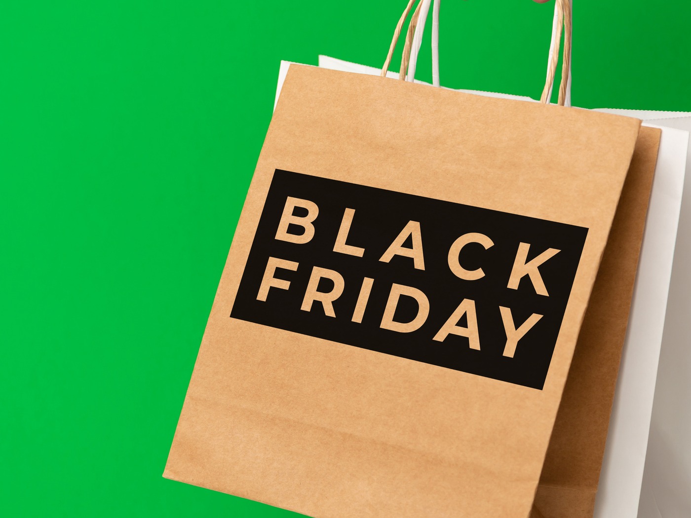 Imagen de fondo verde, bolsa de papel que dice: Black Friday